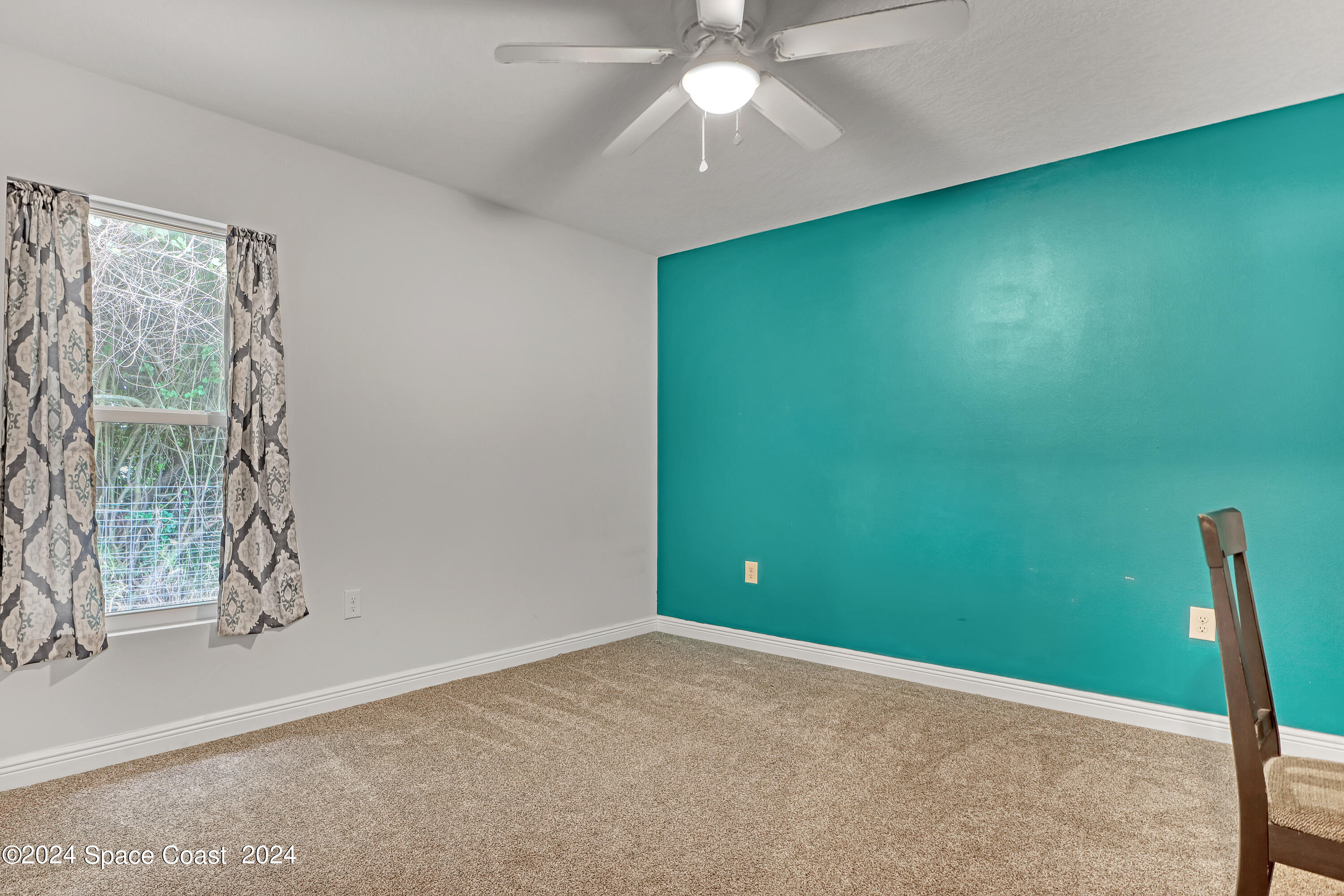 4383 Prentice Lane Mims, FL 32754 - Photo 32 of 48 an empty room with windows and fan