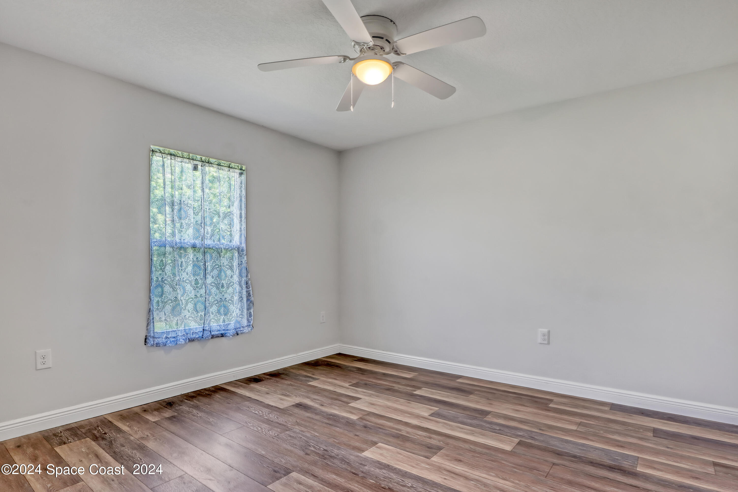 4383 Prentice Lane Mims, FL 32754 - Photo 35 of 48 wooden floor in an empty room with a window