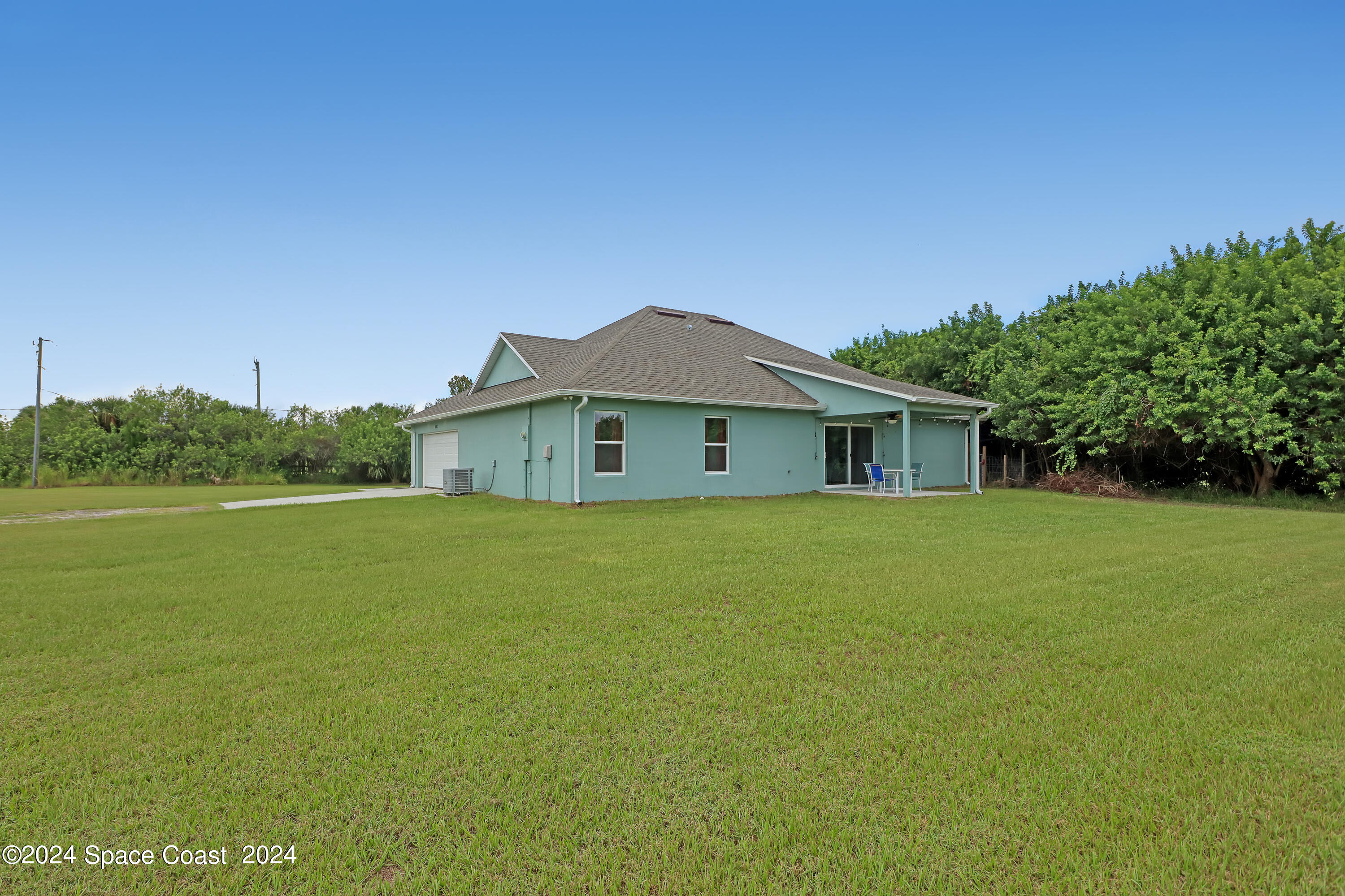 4383 Prentice Lane Mims, FL 32754 - Photo 43 of 48 a front view of a house with garden