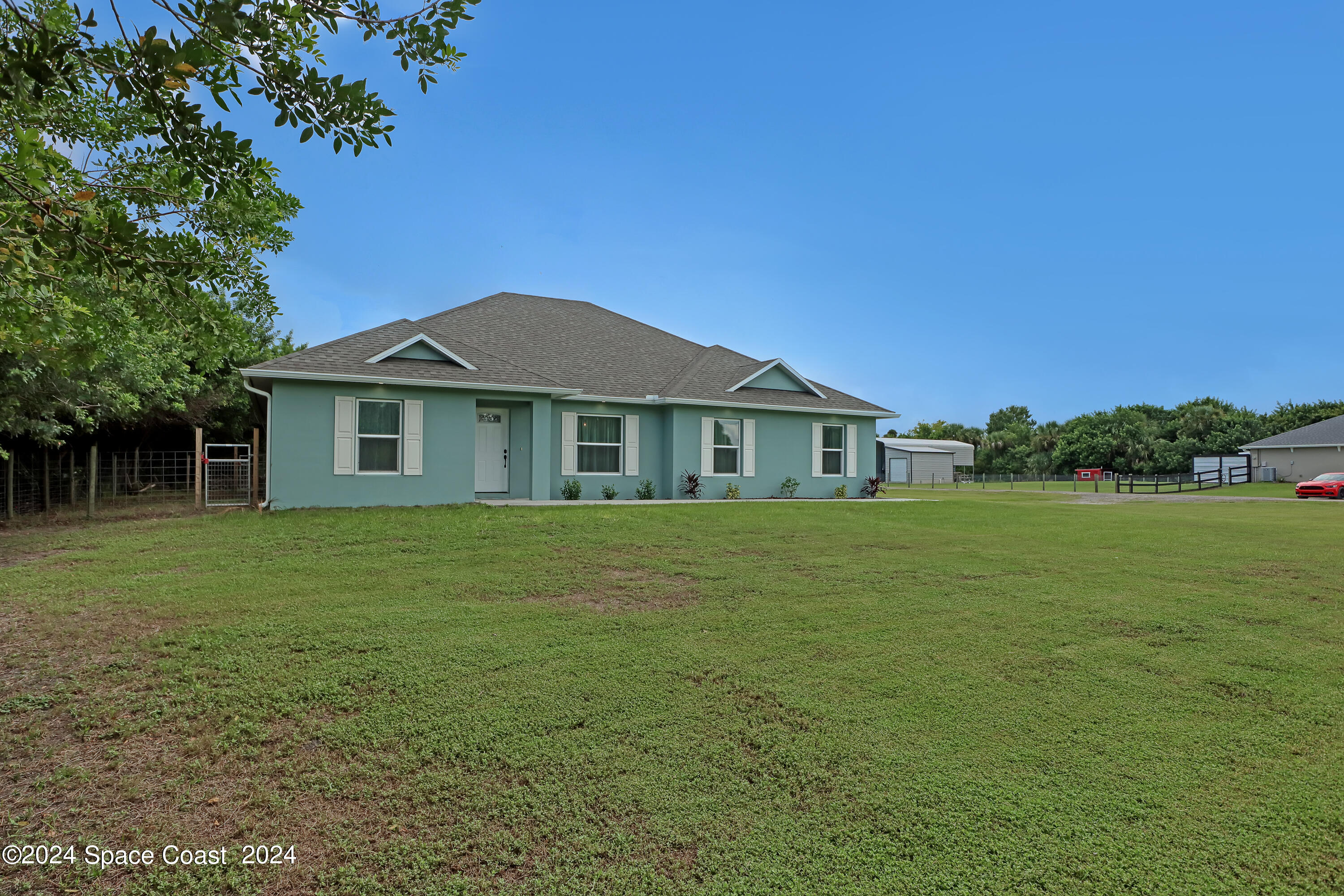 4383 Prentice Lane Mims, FL 32754 - Photo 46 of 48 a front view of a house with a garden