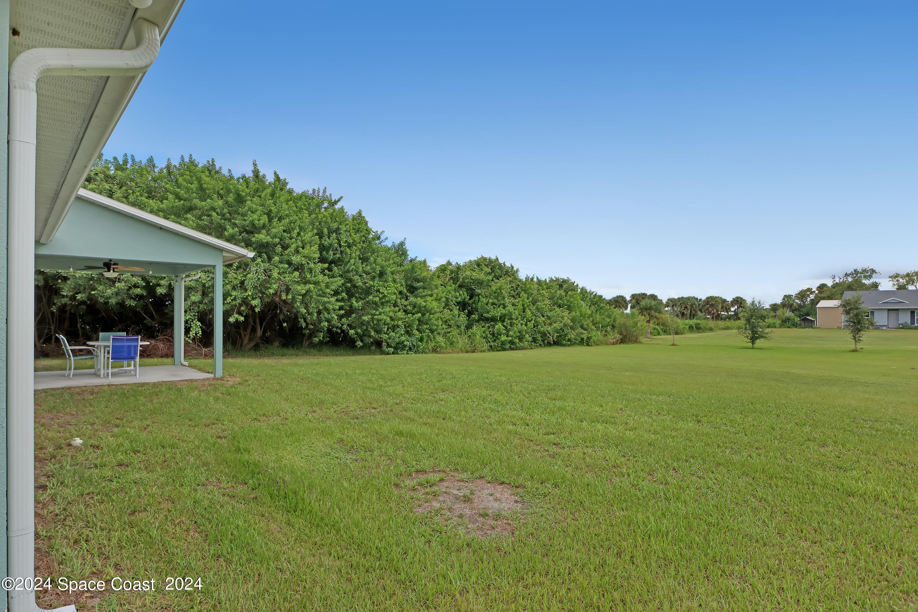 4383 Prentice Lane Mims, FL 32754 - Photo 6 of 48 a view of a green field with wooden fence
