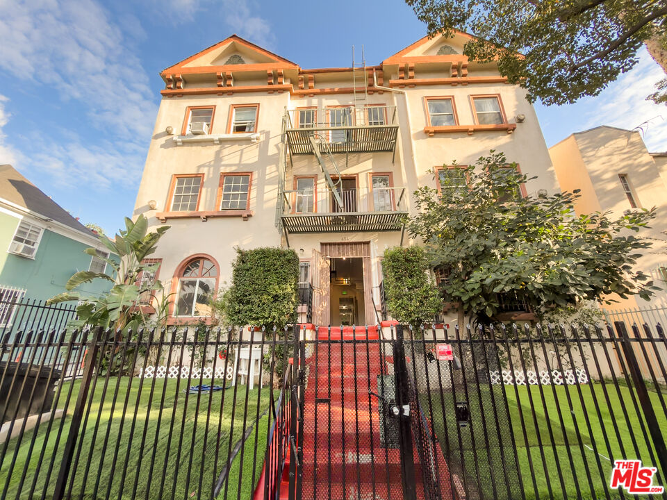 a view of a brick house with many windows