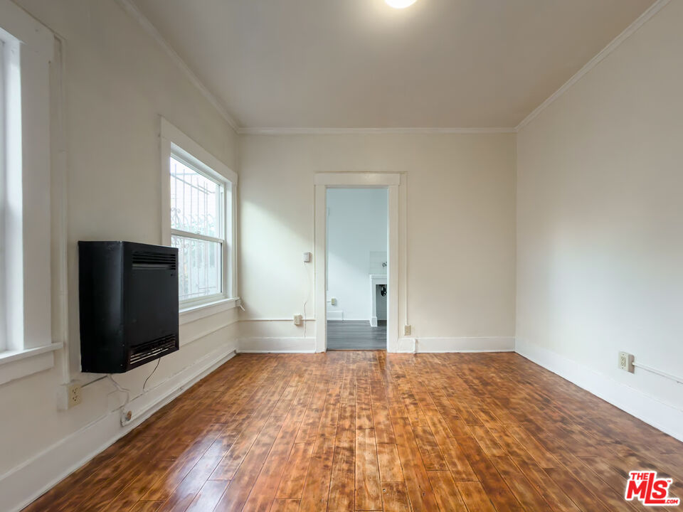 434 South Rampart Boulevard, Unit 108 Los Angeles, CA 90057 - Photo 6 of 18 a view of empty room with wooden floor and fan