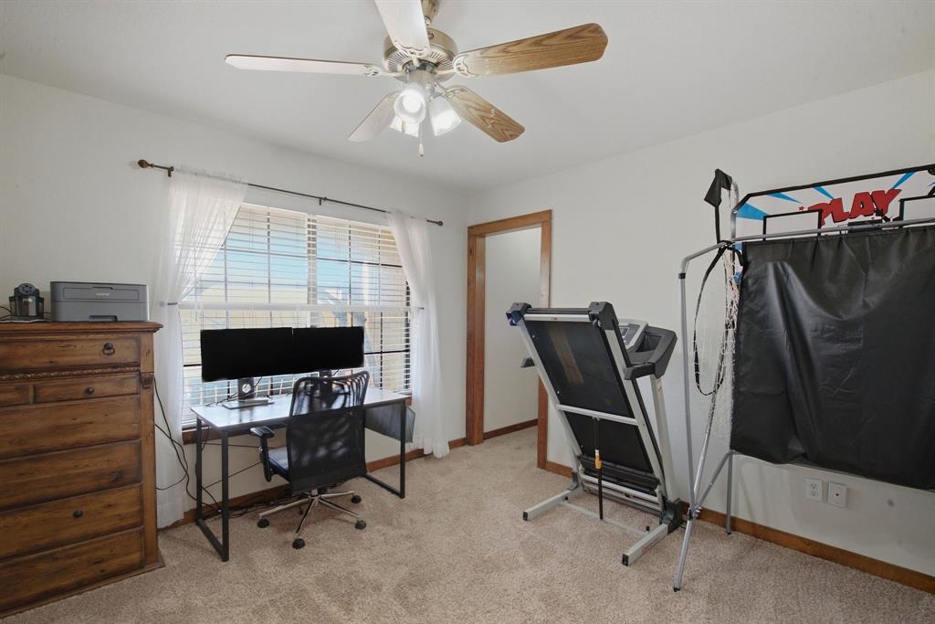 950 Johnson Bend Road Weatherford, TX 76088 - Photo 28 of 40 Recessed window with blinds and sheer curtains, overhead ceiling fan with light fixture, light-toned carpet, and solid wood trim