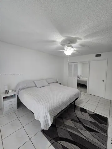 a bed room with a bed and a chair