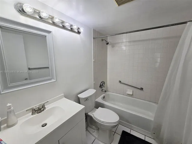 a bathroom with a sink mirror vanity and toilet