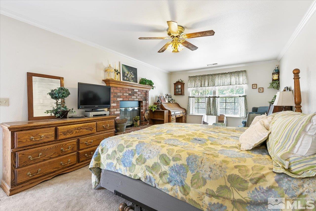 5790 Hooper Place Fallon, NV 89406 - Photo 28 of 39 a bedroom with a bed and a flat tv screen on dresser