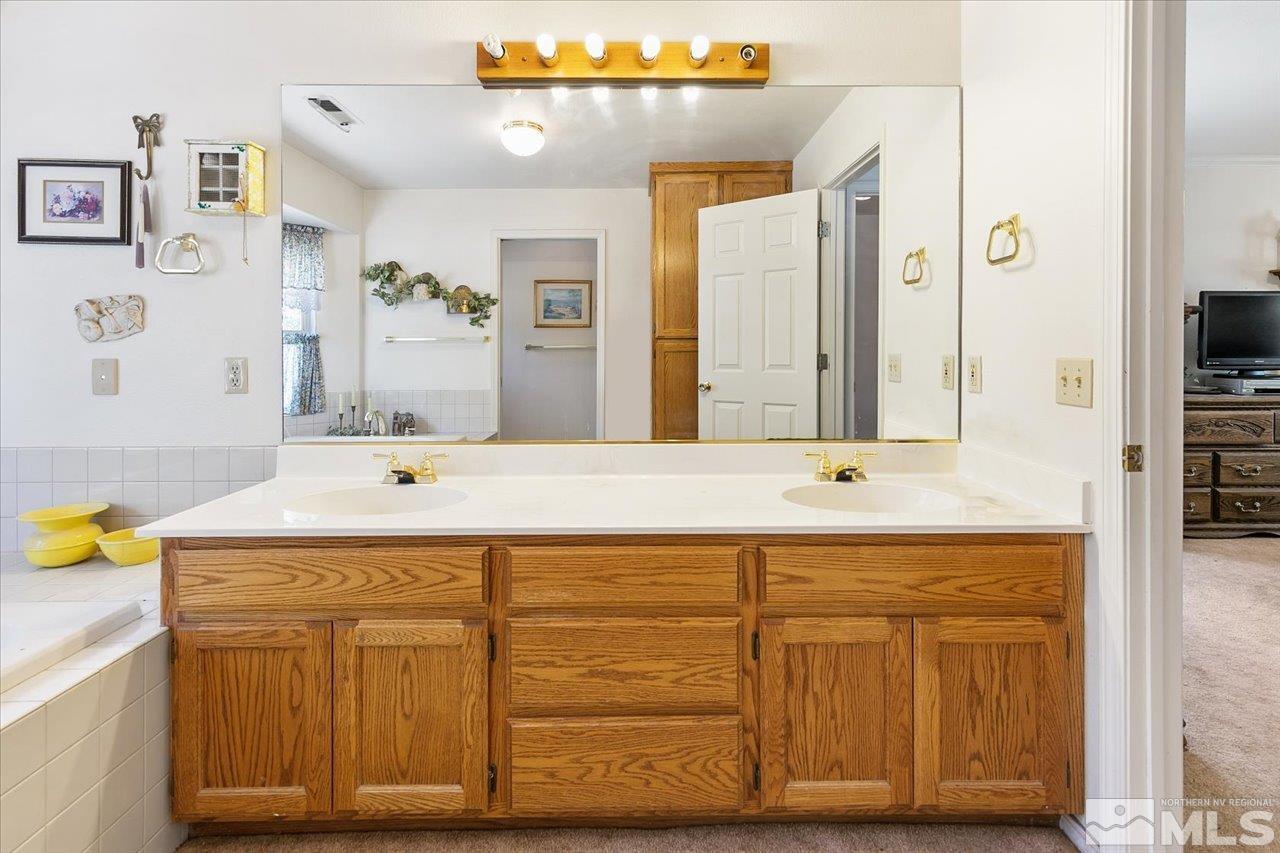 5790 Hooper Place Fallon, NV 89406 - Photo 33 of 39 a bathroom with a sink and a mirror