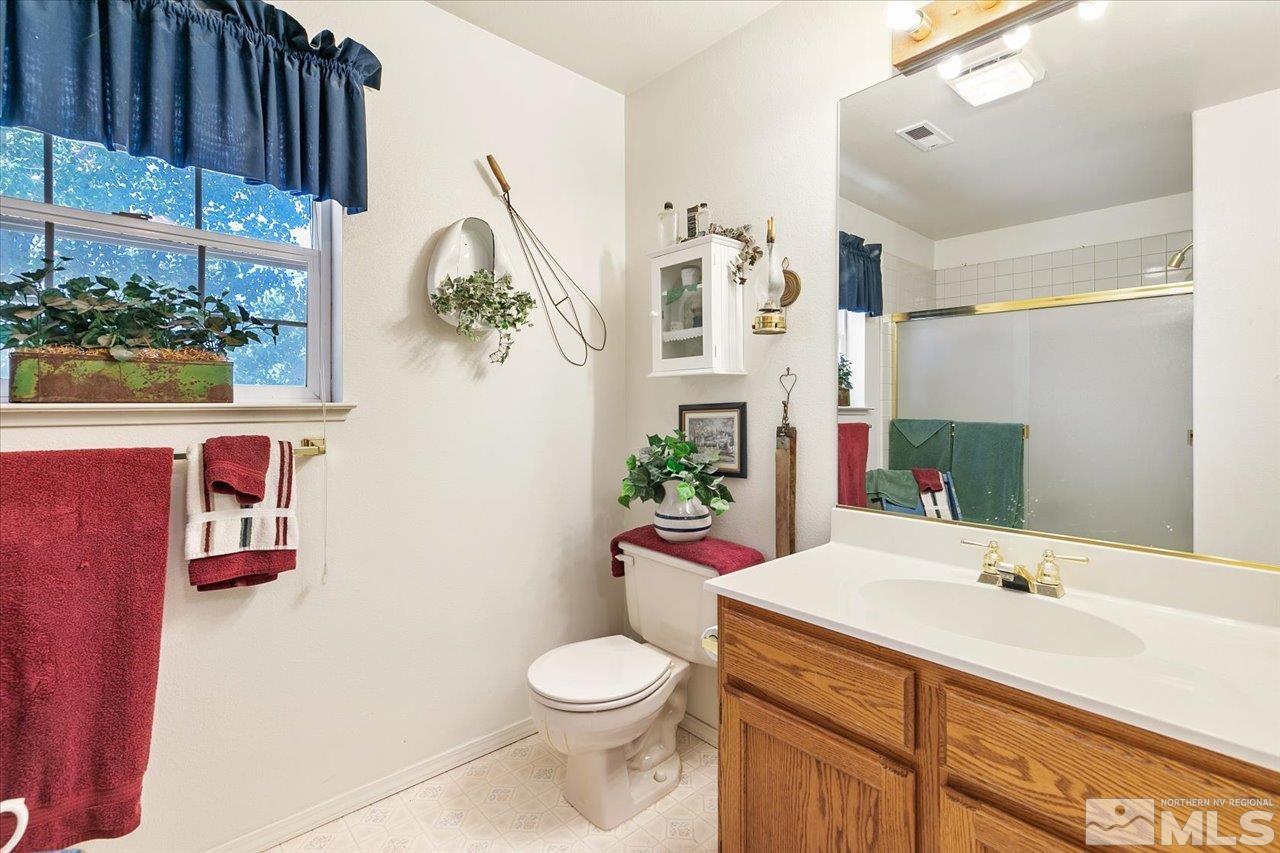 5790 Hooper Place Fallon, NV 89406 - Photo 34 of 39 a bathroom with a sink vanity mirror and toilet