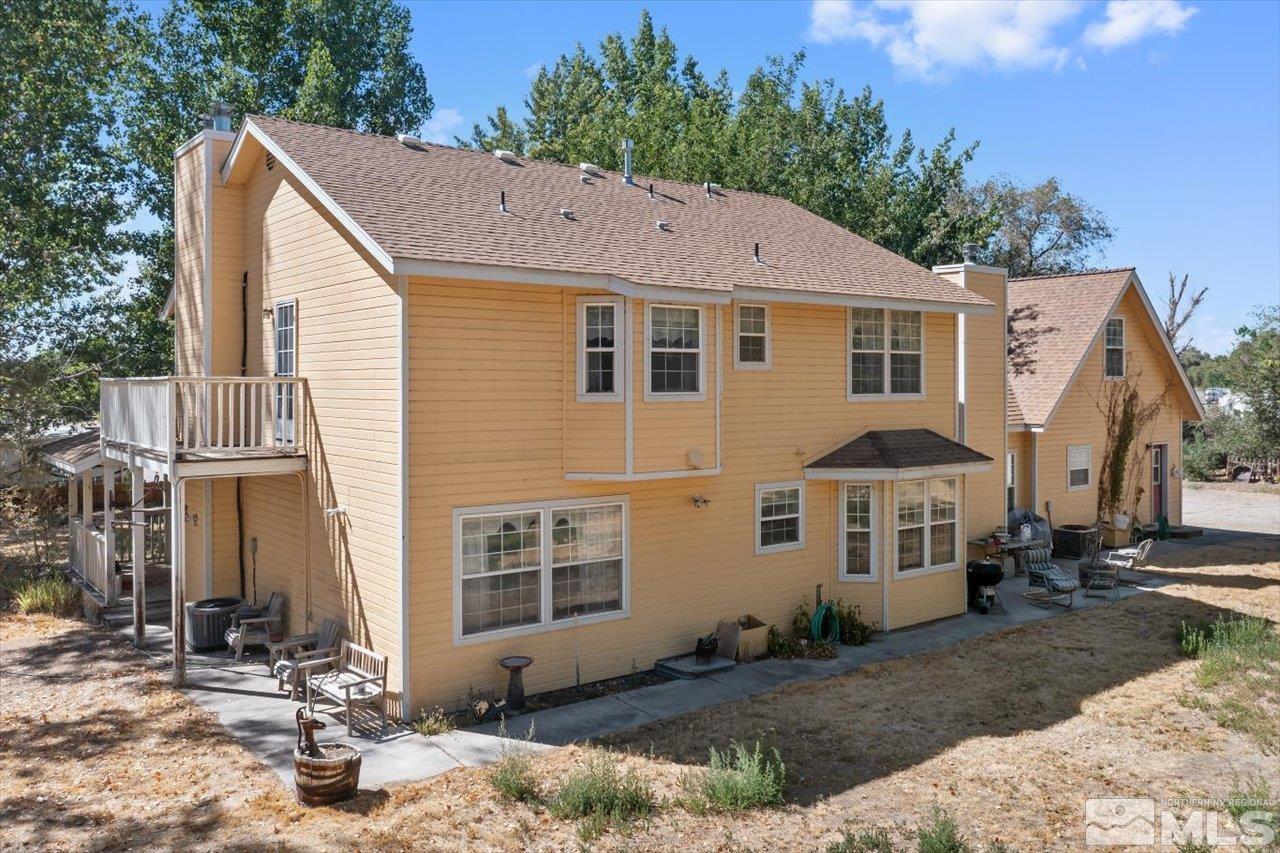 5790 Hooper Place Fallon, NV 89406 - Photo 9 of 39 a view of a white house with large windows next to a road