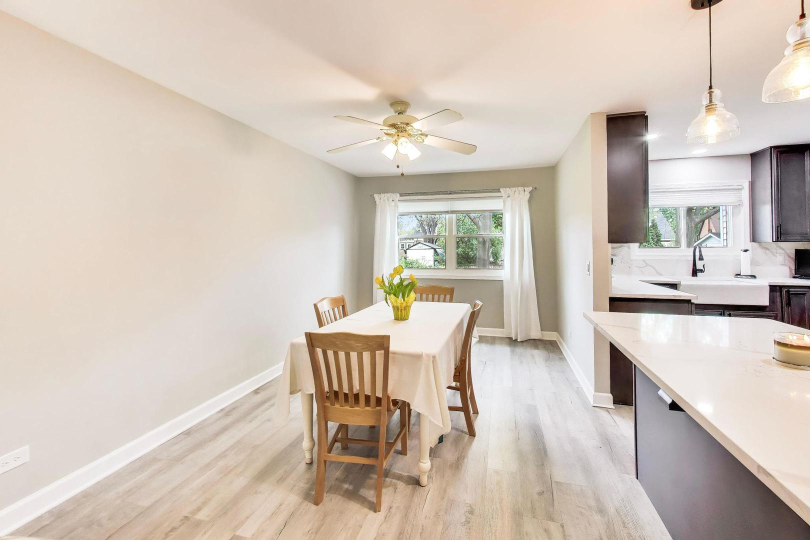 313 South Hi Lusi Avenue Mount Prospect, IL 60056 - Photo 8 of 40 a view of a dining room with furniture a chandelier and wooden floor
