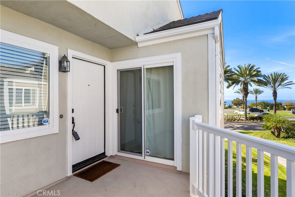 34002 Selva Road, Unit 369 Dana Point, CA 92629 - Photo 6 of 31 a view of a porch with a floor to ceiling window and potted plants