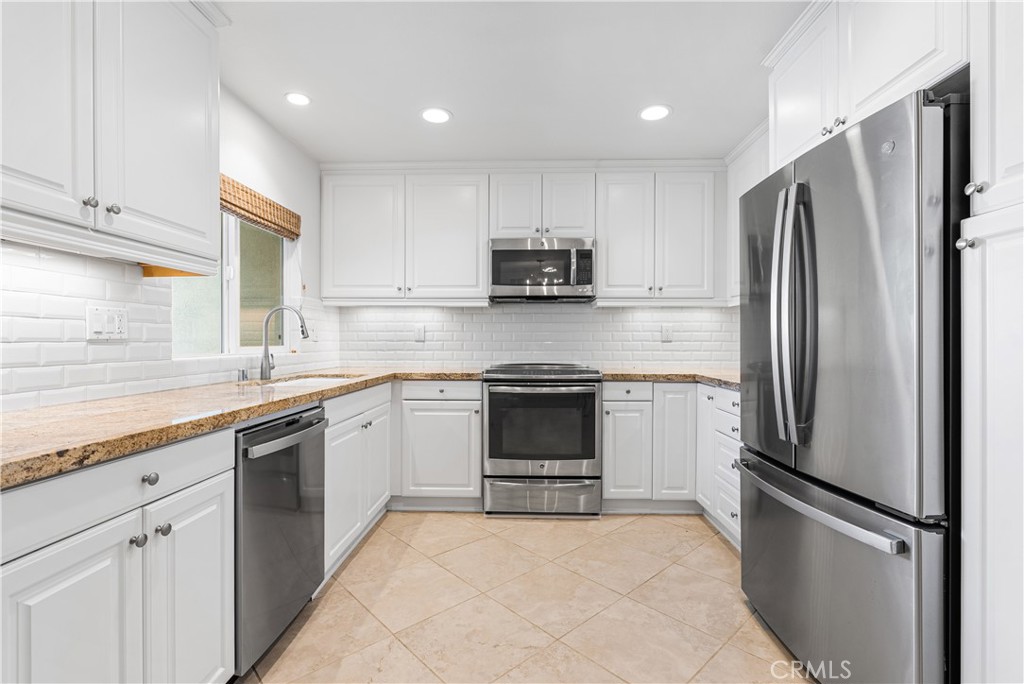34002 Selva Road, Unit 369 Dana Point, CA 92629 - Photo 10 of 31 a kitchen with stainless steel appliances granite countertop a refrigerator sink and stove