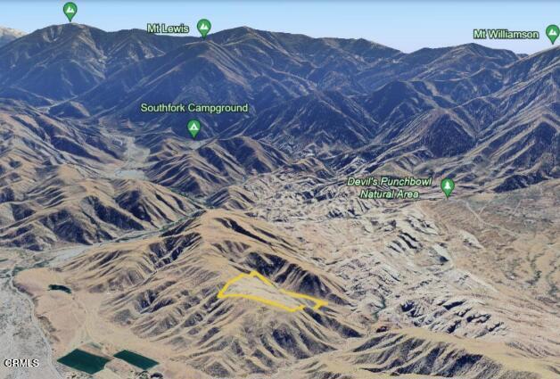 a view of a backyard with a table and chairs