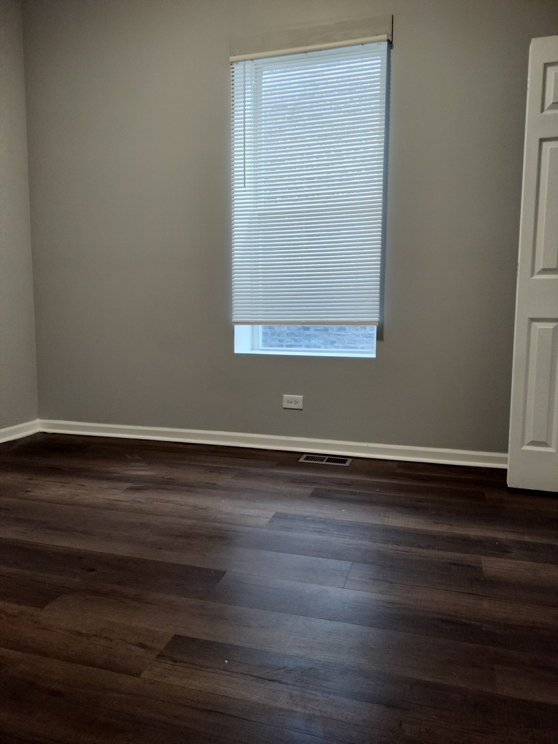 5725 South Green Street, Unit 1 Chicago, IL 60621 - Photo 11 of 18 a view of a small space with wooden floor and a window