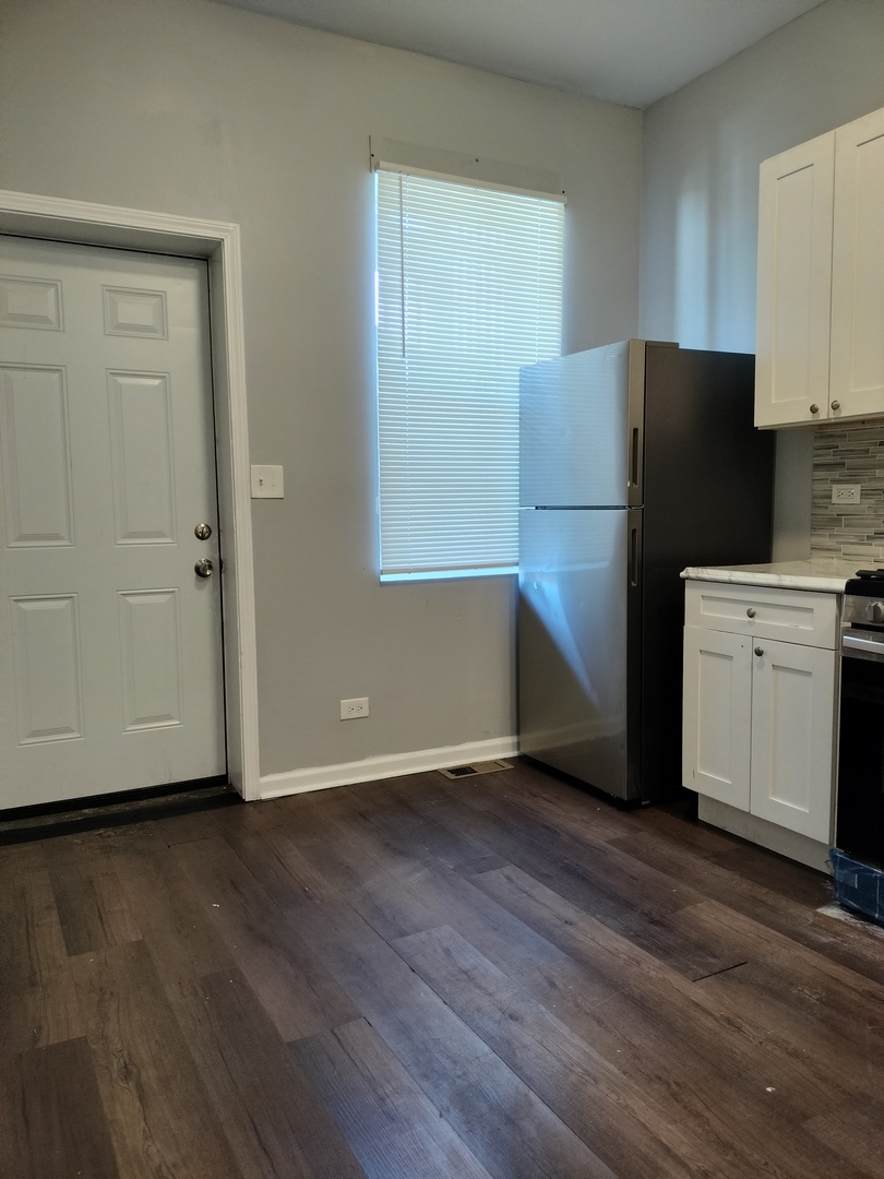 5725 South Green Street, Unit 1 Chicago, IL 60621 - Photo 15 of 18 a kitchen with a refrigerator and a stove top oven
