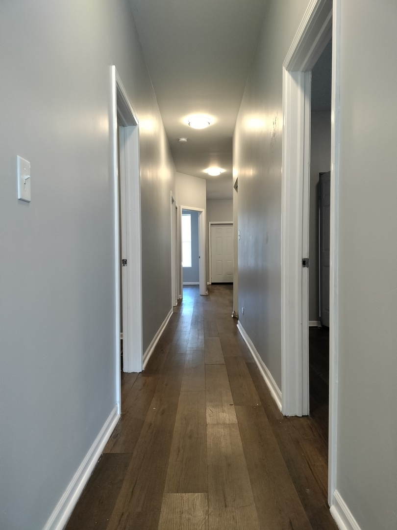 5725 South Green Street, Unit 1 Chicago, IL 60621 - Photo 5 of 18 a view of a hallway with wooden floor
