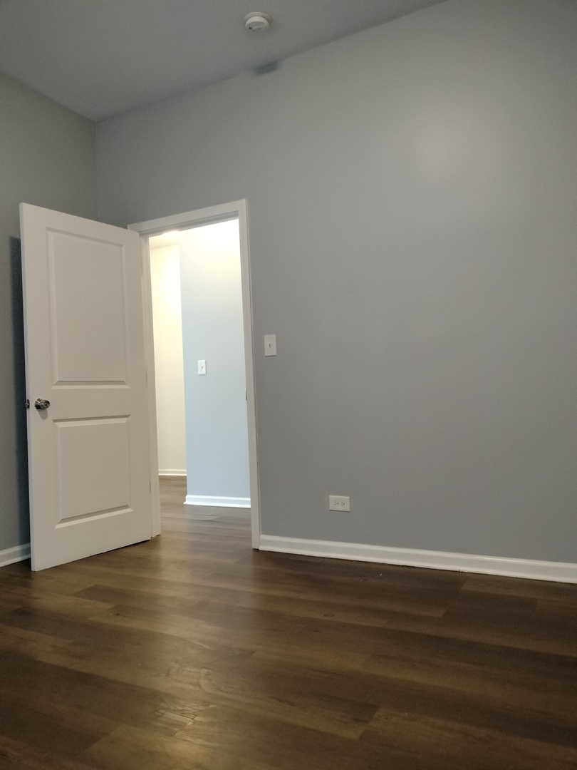 5725 South Green Street, Unit 1 Chicago, IL 60621 - Photo 7 of 18 a view of empty room with wooden floor
