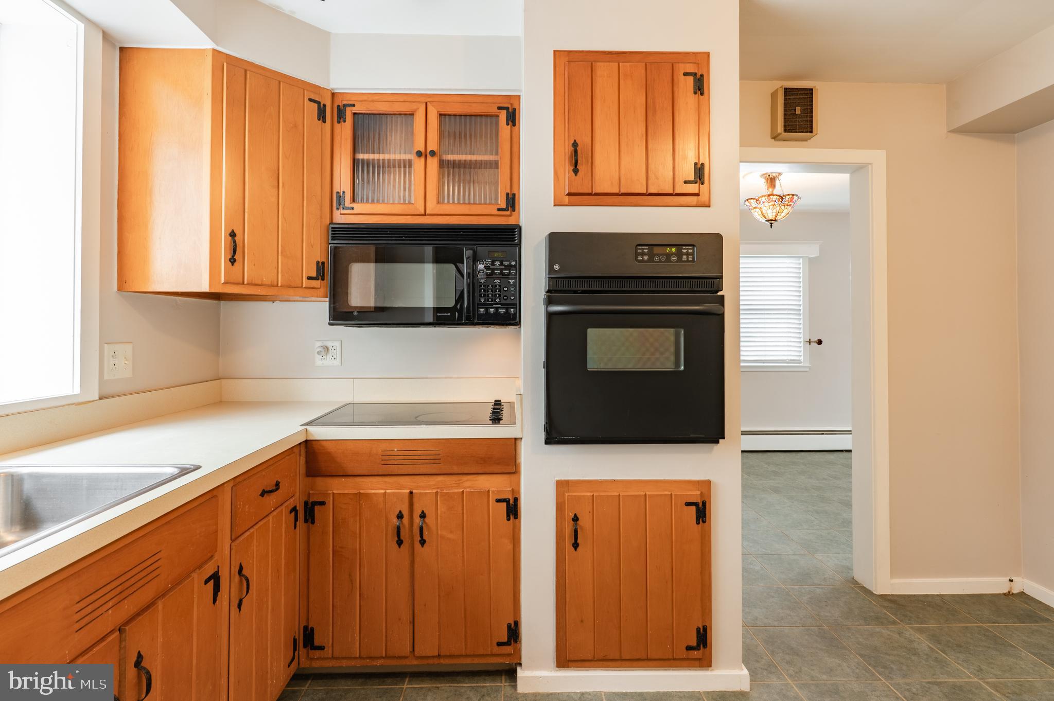 915 Cressman Road Harleysville, PA 19438 - Photo 12 of 39 a kitchen with granite countertop wooden cabinets and a stove top oven