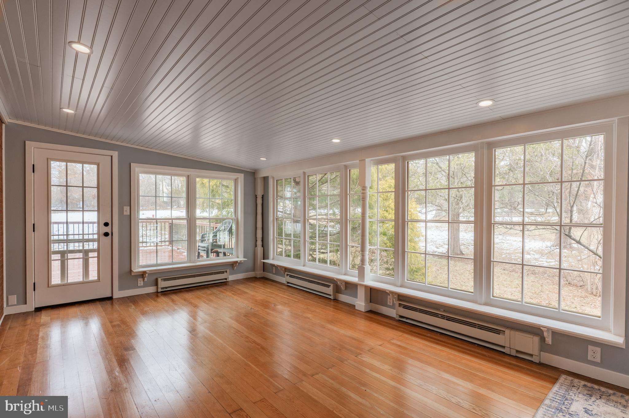 915 Cressman Road Harleysville, PA 19438 - Photo 14 of 39 a view of an empty room with wooden floor and a window