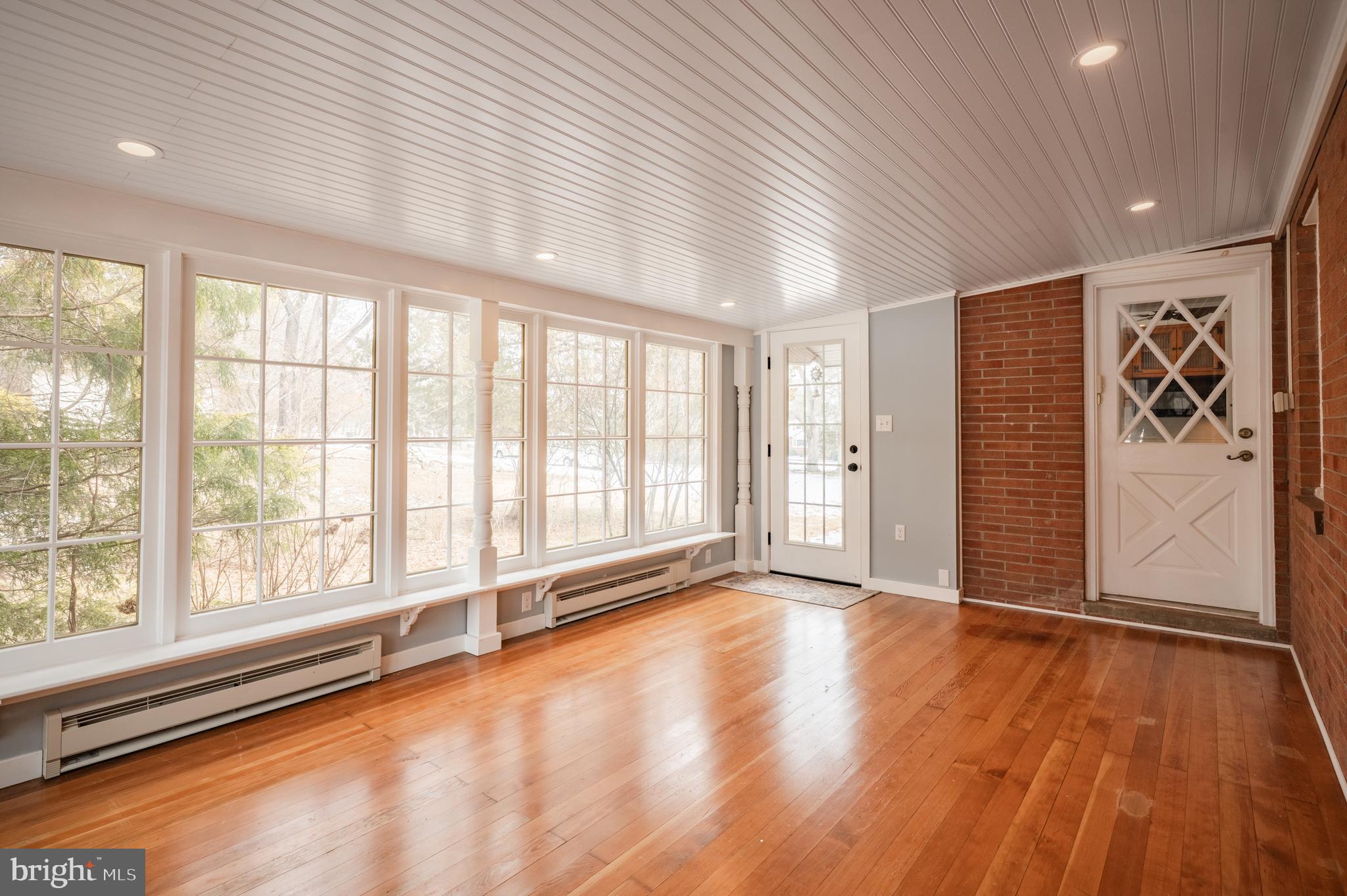 915 Cressman Road Harleysville, PA 19438 - Photo 15 of 39 a view of an empty room with a window and wooden floor