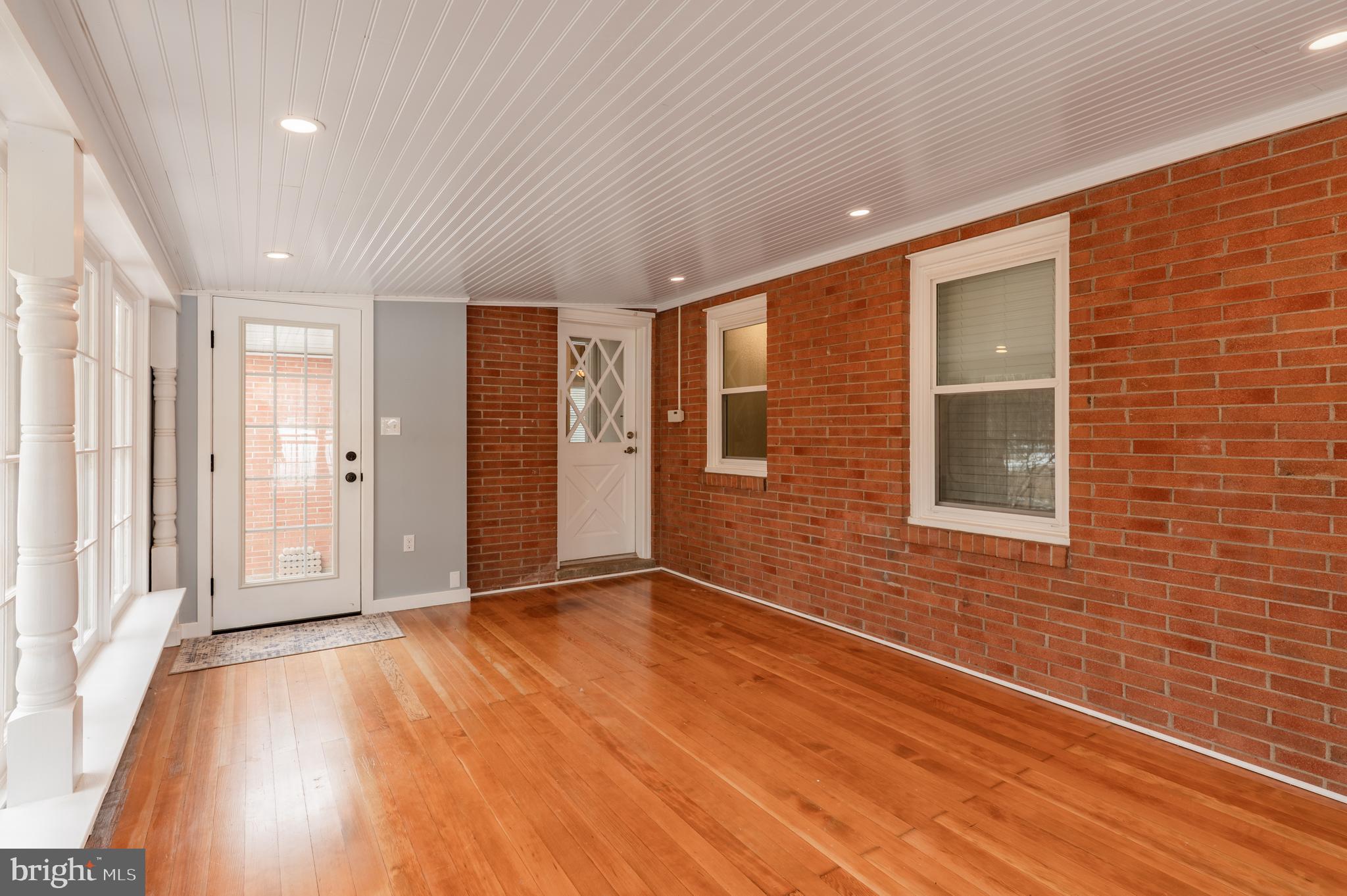 915 Cressman Road Harleysville, PA 19438 - Photo 16 of 39 a view of an empty room with wooden floor and a window