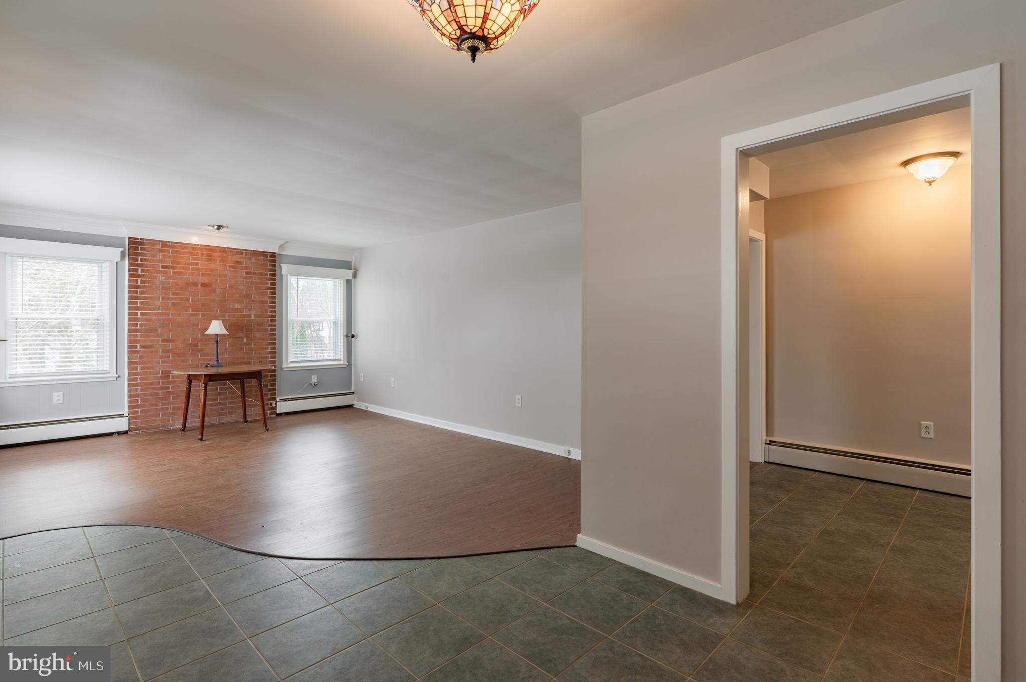 915 Cressman Road Harleysville, PA 19438 - Photo 9 of 39 an empty room with wooden floor and windows