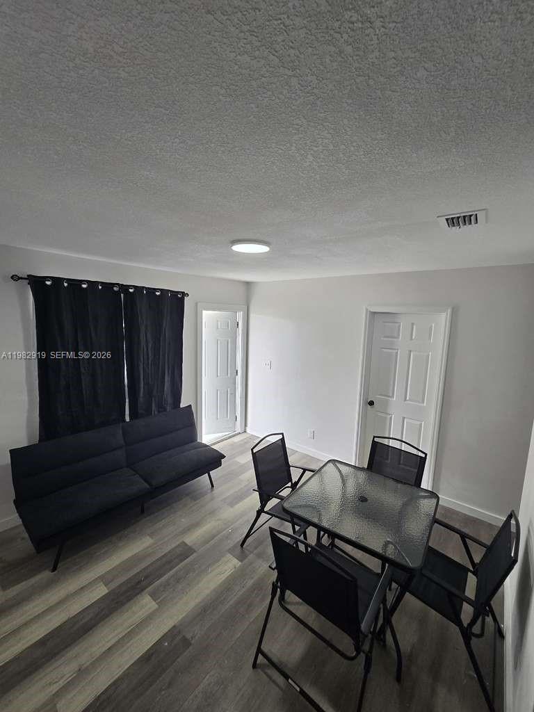 26633 Southwest 138th Court, Unit 1 Homestead, FL 33032 - Photo 3 of 8 a living room with furniture and wooden floor