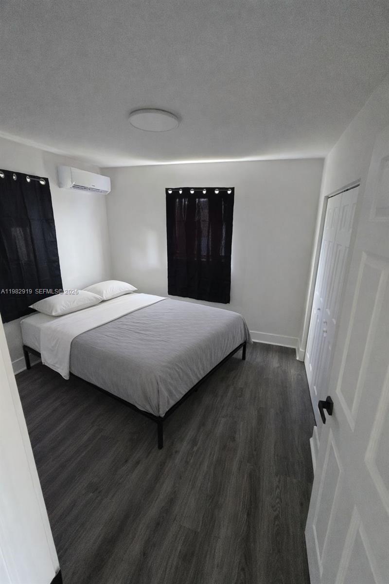 26633 Southwest 138th Court, Unit 1 Homestead, FL 33032 - Photo 6 of 8 a bedroom with a bed and a dresser