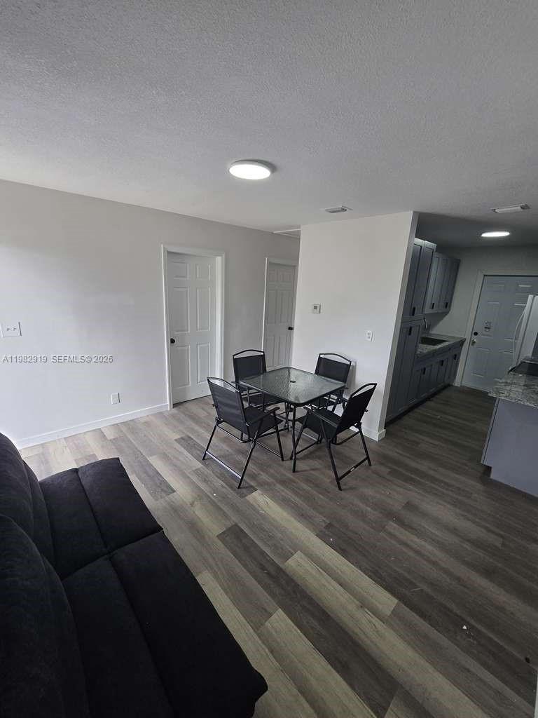 26633 Southwest 138th Court, Unit 1 Homestead, FL 33032 - Photo 7 of 8 a living room with furniture and a wooden floor