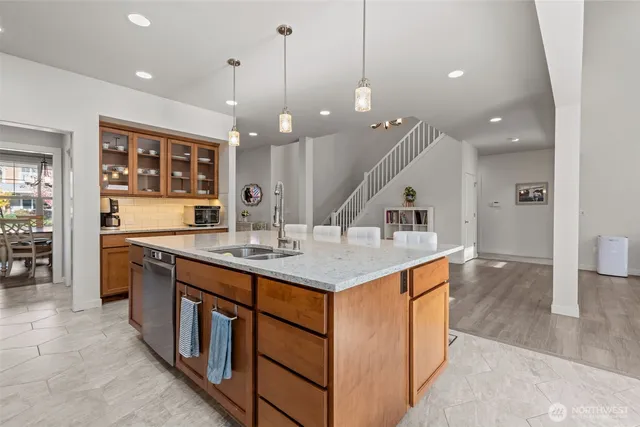 a kitchen with stainless steel appliances kitchen island a large island in the center and cabinets