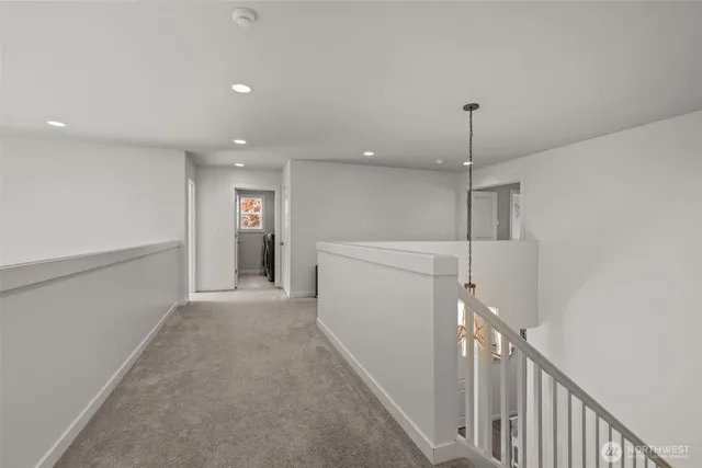 a spacious bedroom with a bed and a chandelier