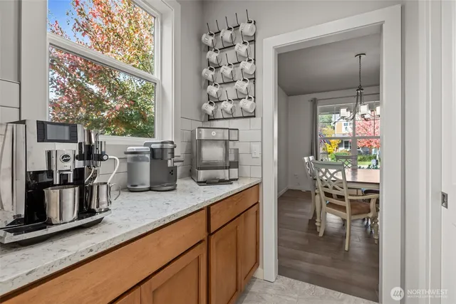a kitchen with a table chairs and cabinets