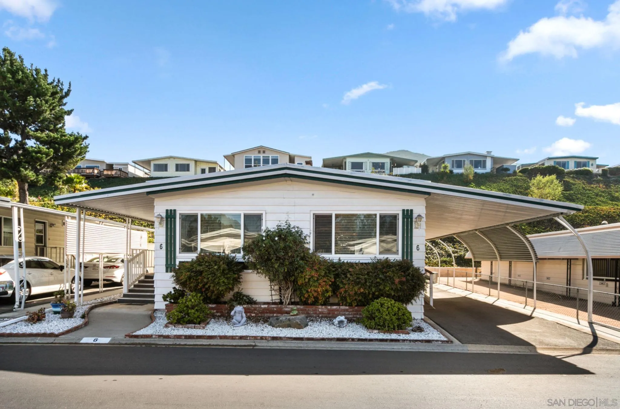 7467 Mission Gorge Road, Unit 6 Santee, CA 92071 - Photo 1 of 14 a front view of a house with garden