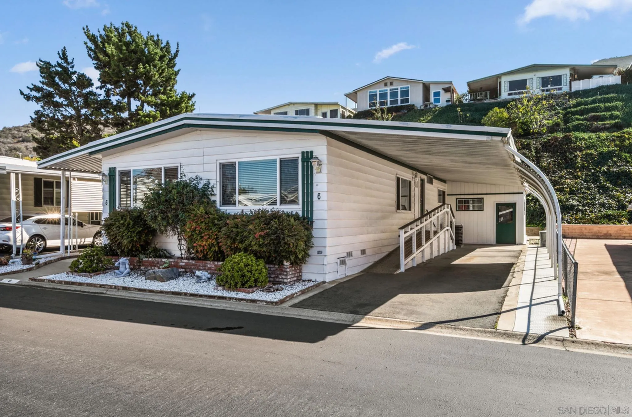 7467 Mission Gorge Road, Unit 6 Santee, CA 92071 - Photo 2 of 14 a front view of a house with garden