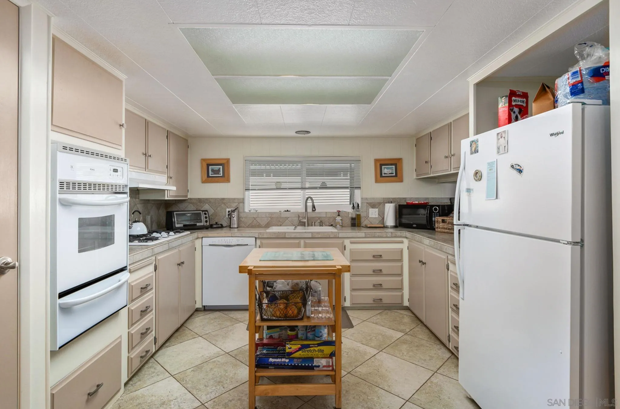 7467 Mission Gorge Road, Unit 6 Santee, CA 92071 - Photo 5 of 14 a kitchen with white cabinets and white appliances