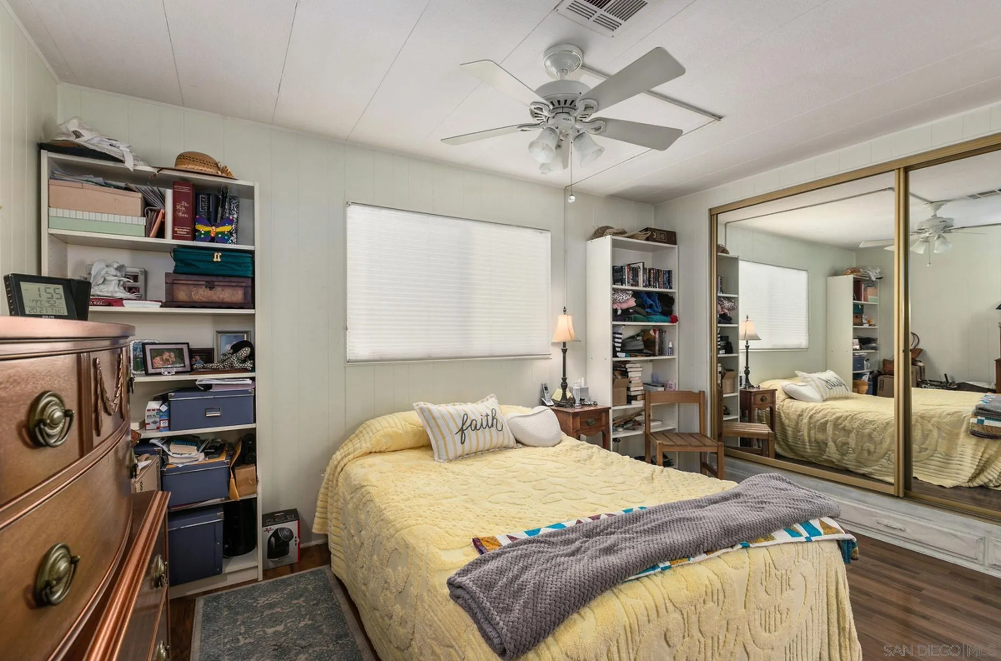 7467 Mission Gorge Road, Unit 6 Santee, CA 92071 - Photo 7 of 14 a bedroom with a large bed and a chandelier