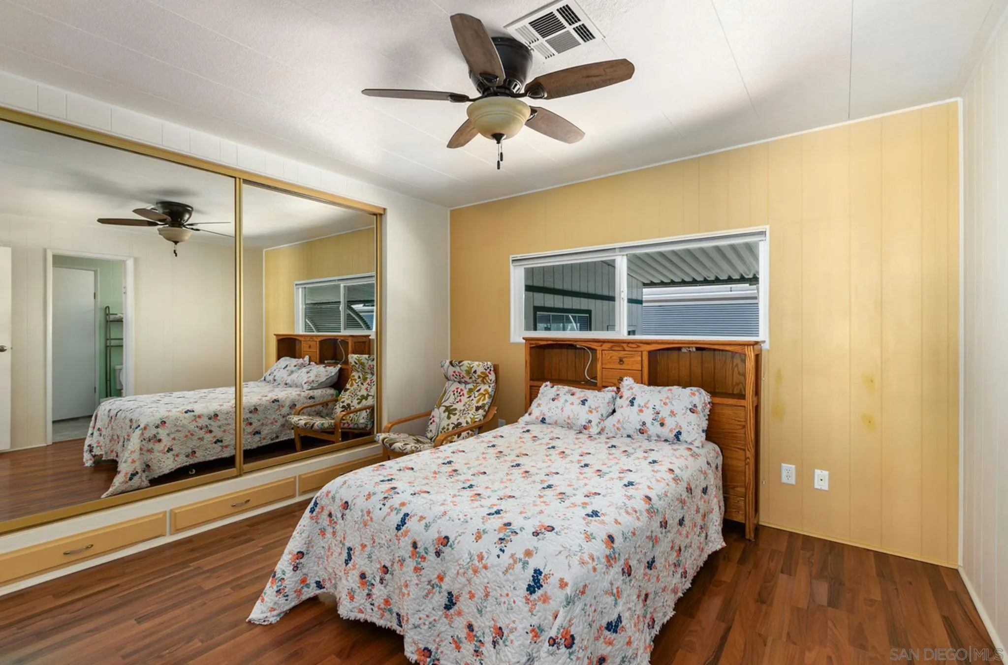 7467 Mission Gorge Road, Unit 6 Santee, CA 92071 - Photo 9 of 14 a bedroom with a bed and a chandelier