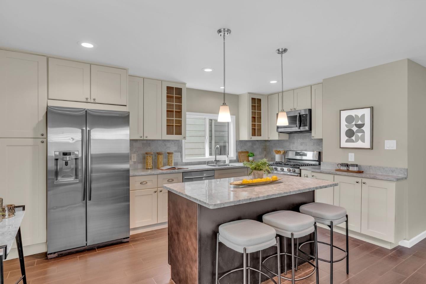 363 Pacific Avenue Pacifica, CA 94044 - Photo 15 of 70 a kitchen with stainless steel appliances a refrigerator a sink a stove a dining table and chairs