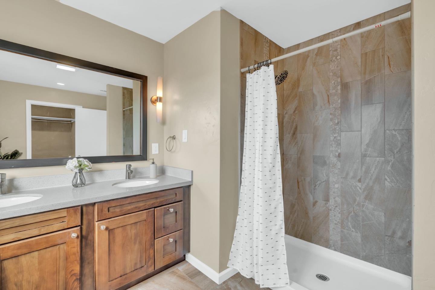 363 Pacific Avenue Pacifica, CA 94044 - Photo 32 of 70 a bathroom with a granite countertop sink shower and a mirror