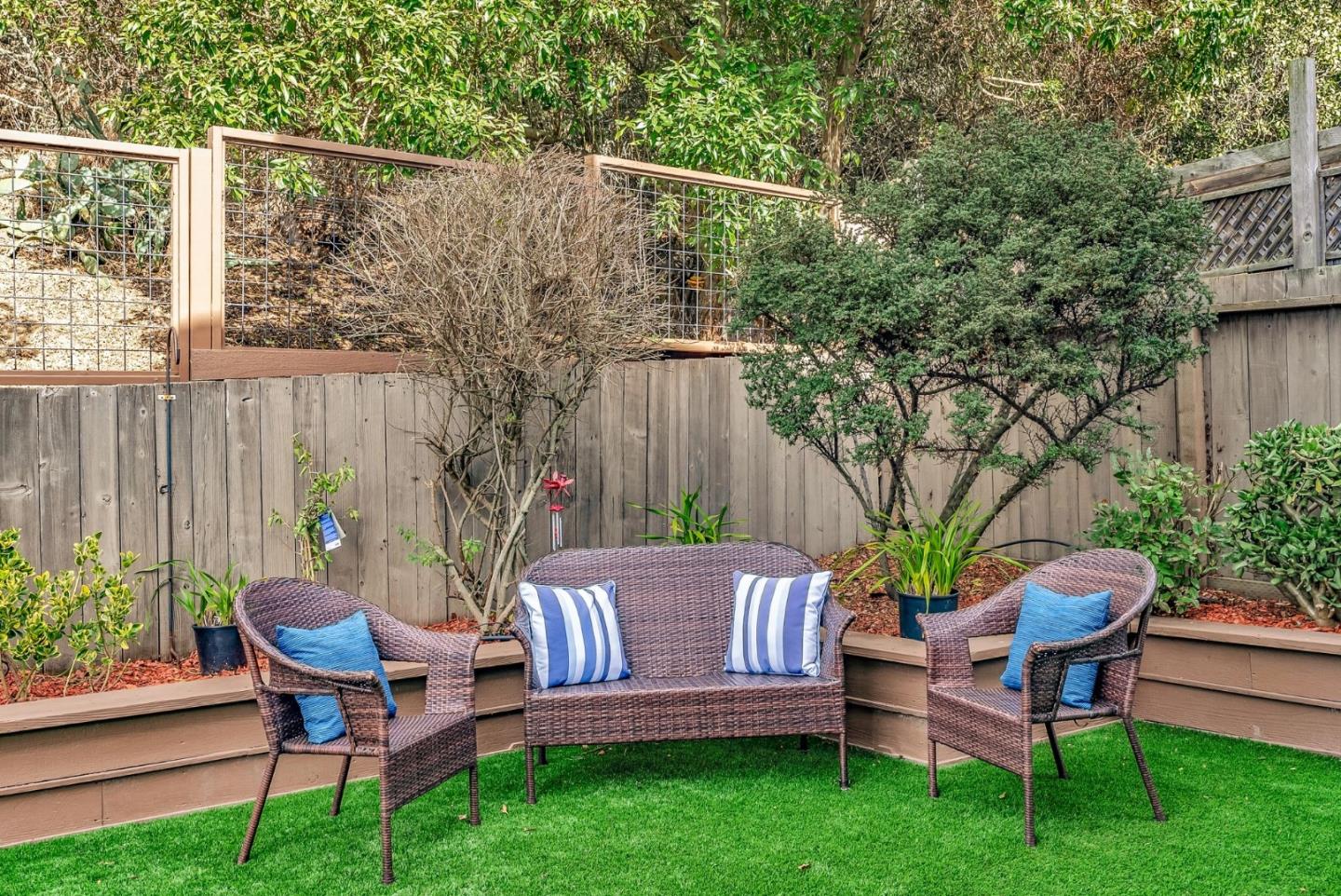 363 Pacific Avenue Pacifica, CA 94044 - Photo 52 of 70 a view of a chairs and table in backyard of the house