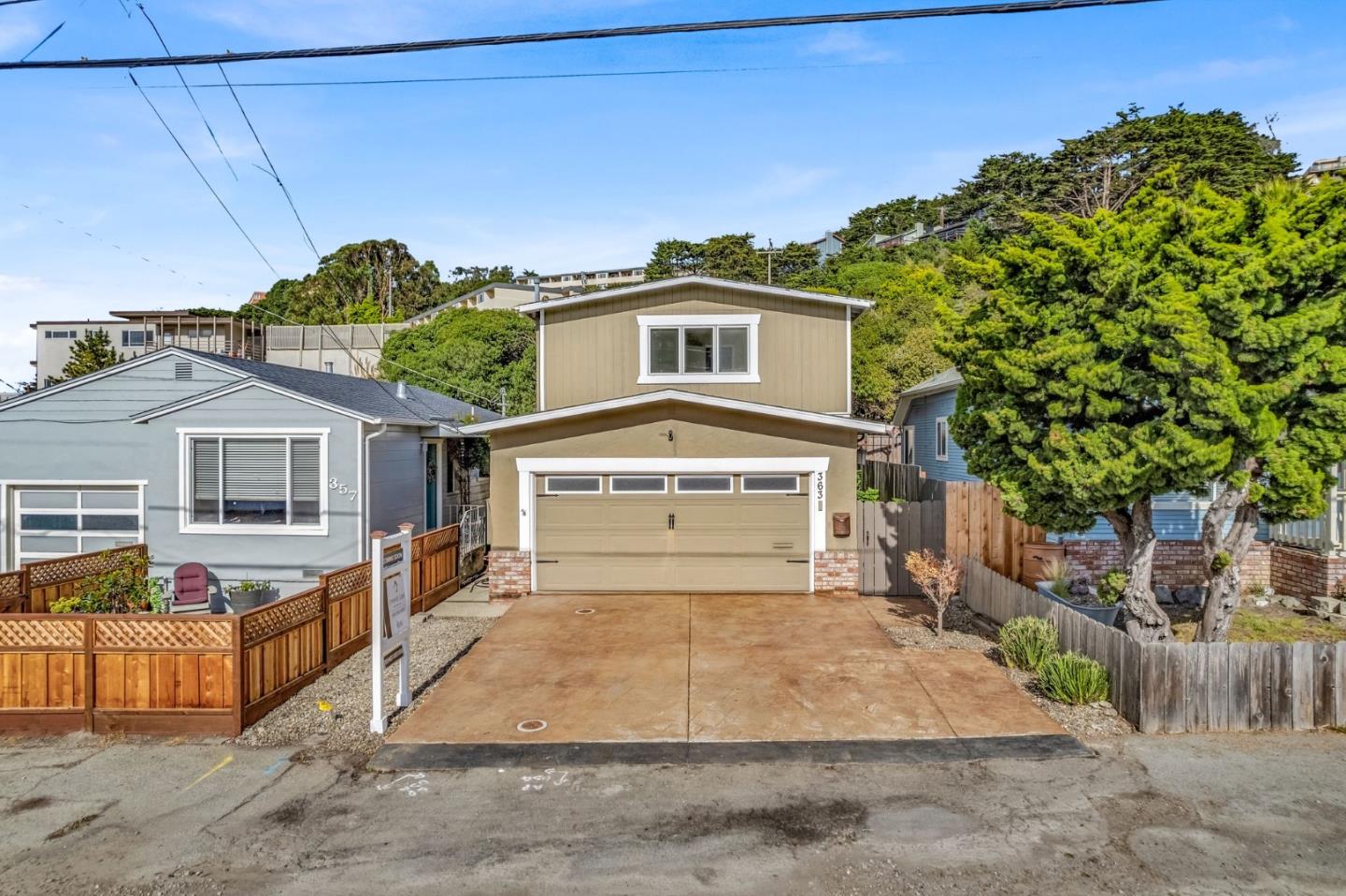 363 Pacific Avenue Pacifica, CA 94044 - Photo 61 of 70 a front view of a house with a yard and garage