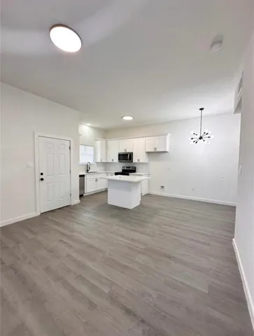 a view of a kitchen with a sink dishwasher and a refrigerator
