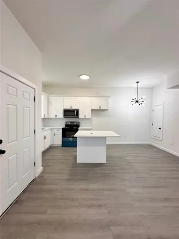 a view of living room with furniture and wooden floor