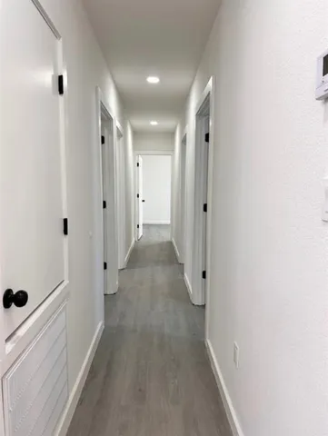 a view of a hallway with white walls