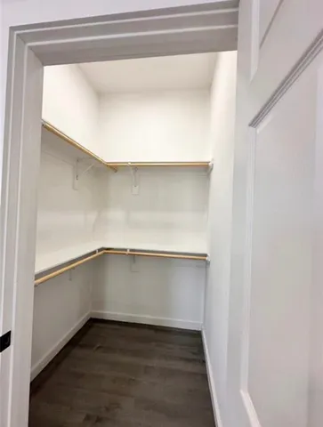 a an empty room with a wooden floor