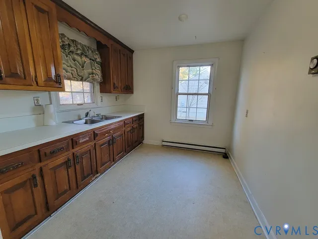 a kitchen with stainless steel appliances granite countertop a sink dishwasher a stove and a refrigerator with wooden cabinets