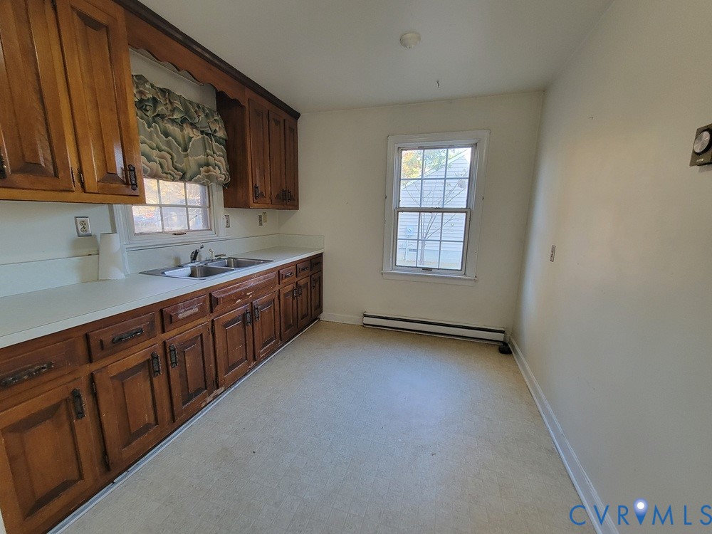 515 18th Street West Point, VA 23181 - Photo 22 of 23 a kitchen with stainless steel appliances granite countertop a sink dishwasher a stove and a refrigerator with wooden cabinets