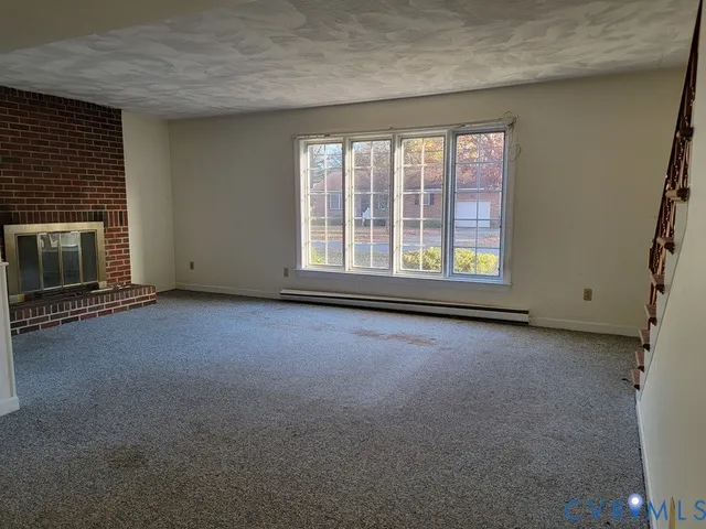 an empty room with a fireplace