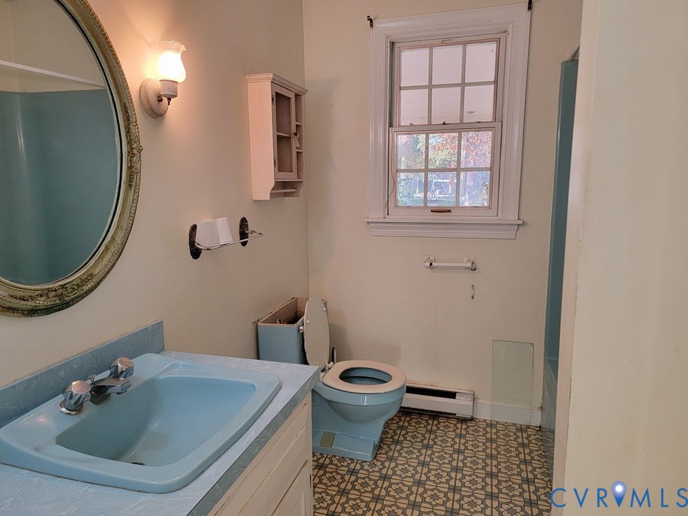 515 18th Street West Point, VA 23181 - Photo 8 of 23 a bathroom with a sink a toilet and a mirror